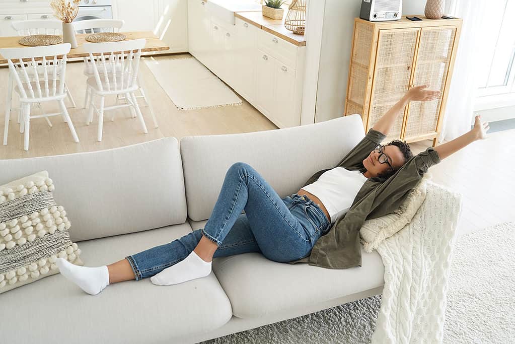 Girl laying down on a sofa in the home