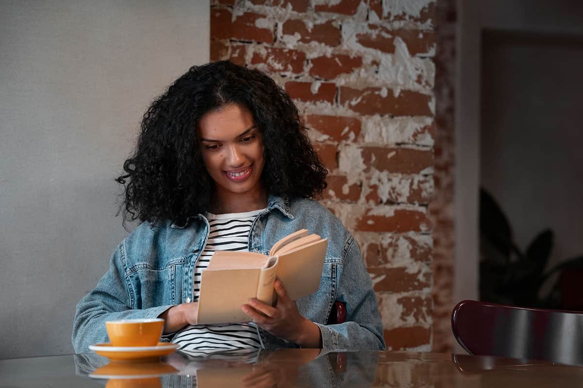 woman reading a book in a coffee shop